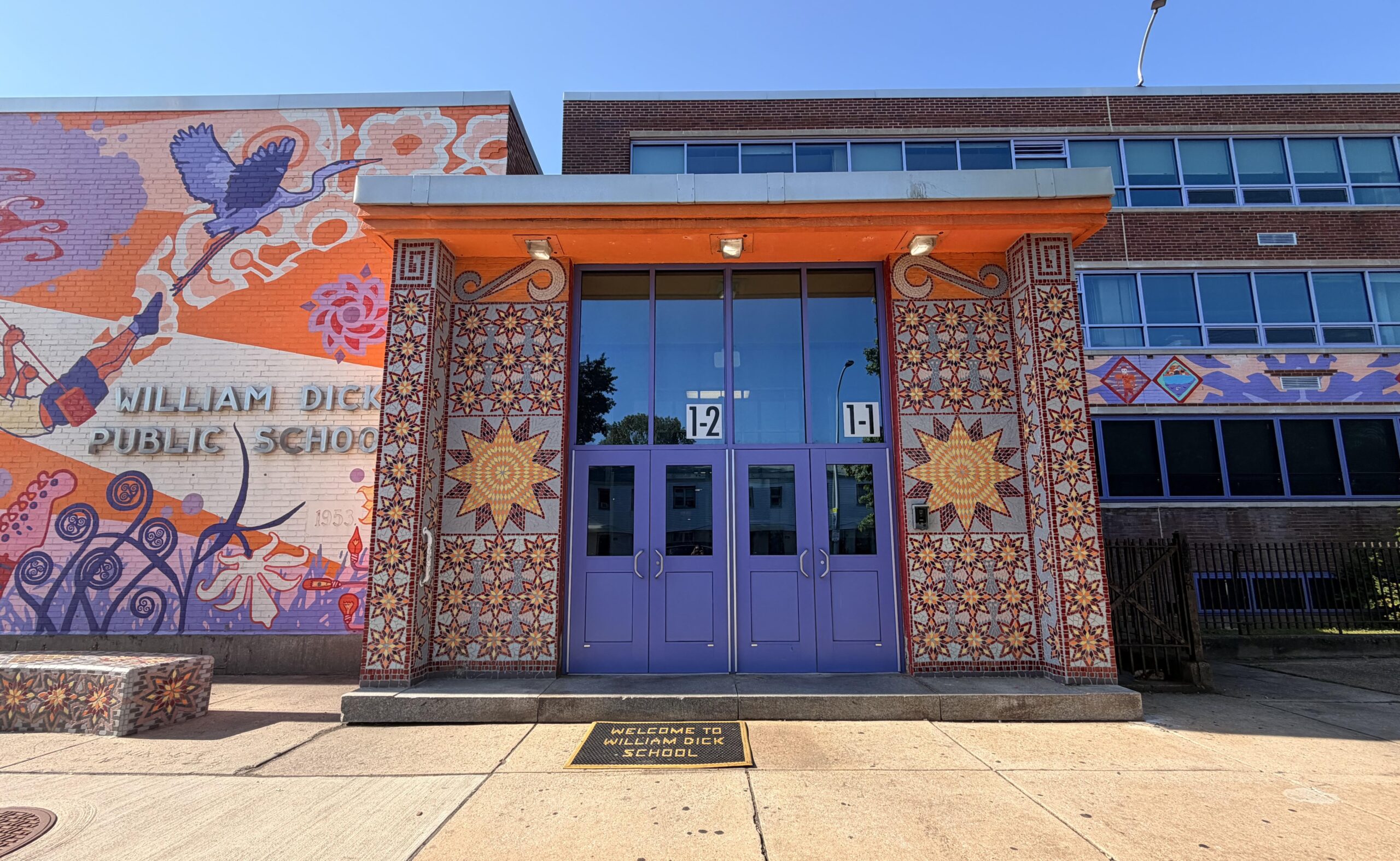 William Dick School Entrance2 Colorful mural and mosaic artwork surrounding the main entrance of William Dick School.